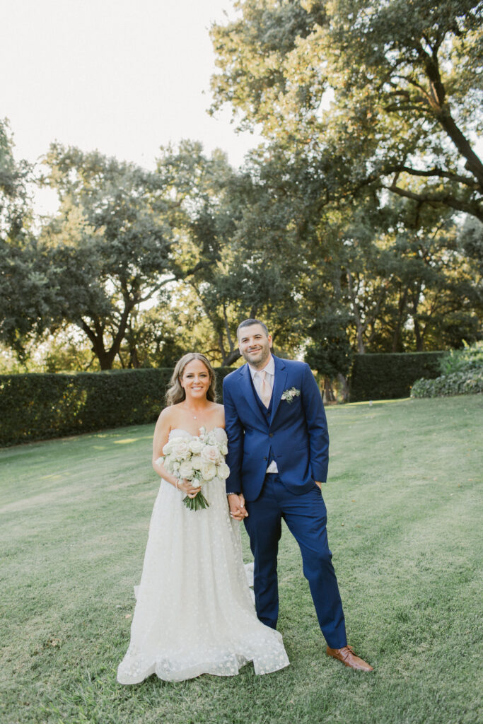Romantic portrait of the bride and groom during golden hour, with the golden light casting a beautiful glow over their faces and the surrounding landscape.
