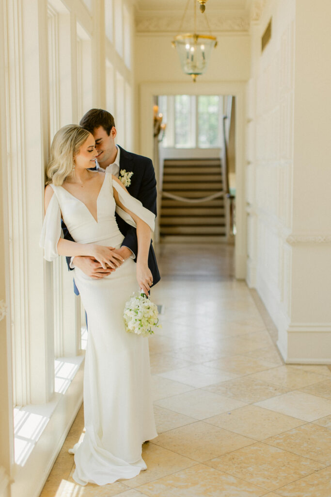 Romantic couple portrait with heads gently touching in an elegant hallway