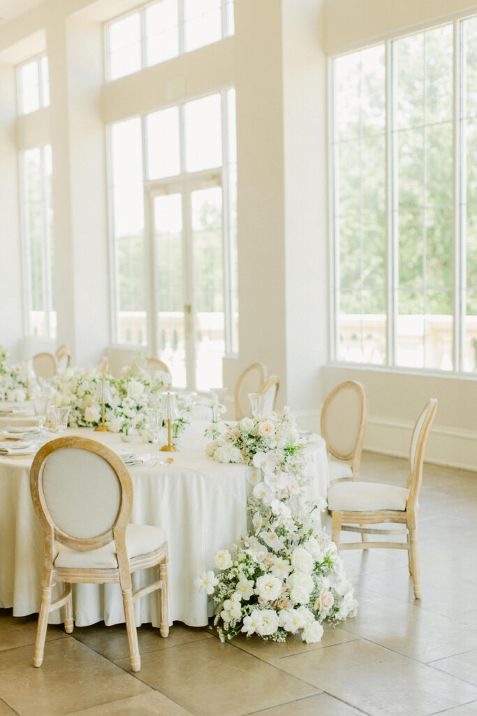 green and white wedding reception table with gold accents