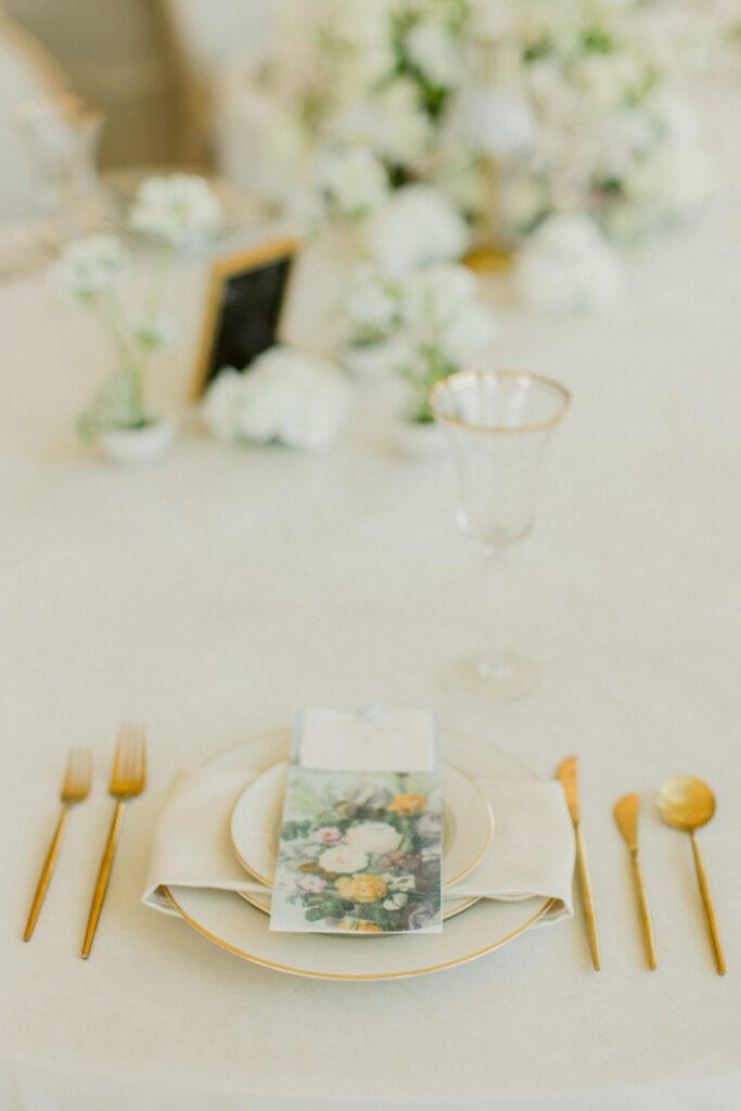 green and white wedding reception table setting with place card