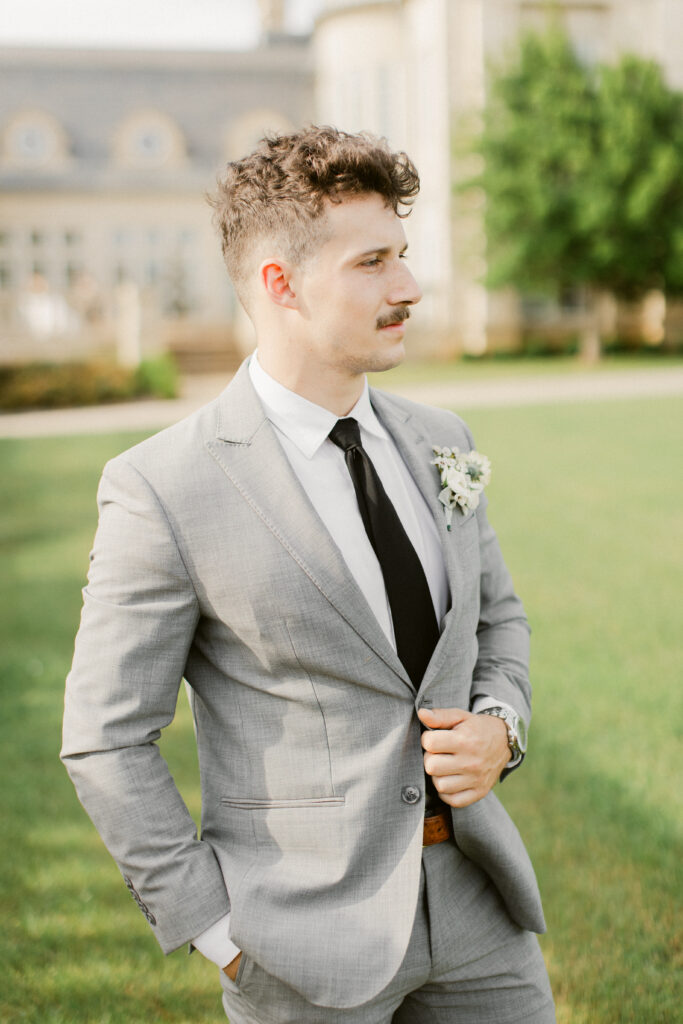 Groom smiling warmly near The Olana’s outdoor ceremony area