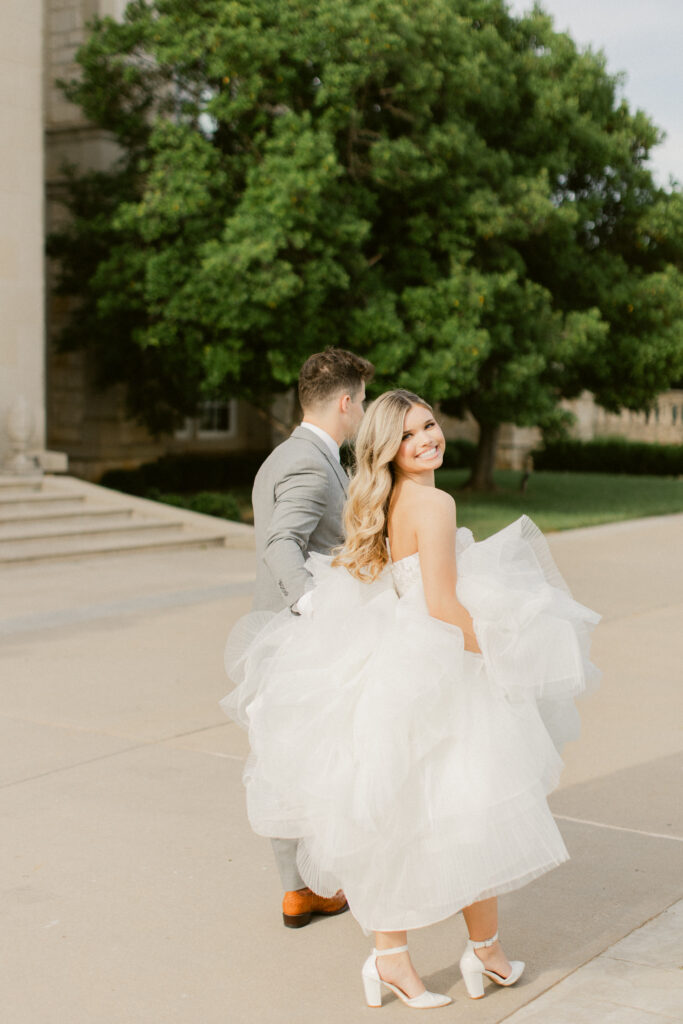 Bride and groom walking through garden paths at The Olana