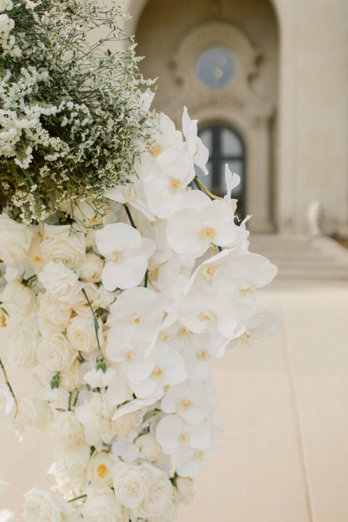 Floral-draped arbor with white roses and orchids at The Olana