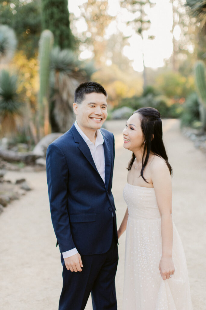 Candid moment between engaged couple at Stanford Cactus Garden in winter