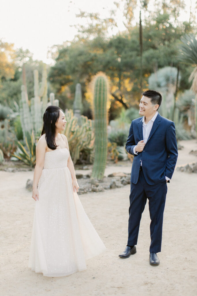 Engaged couple laughing together at the Stanford Cactus Garden
