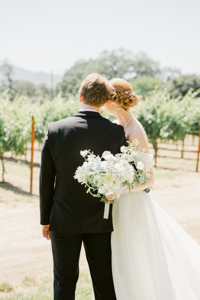 Portrait of couple looking at the vineyard before their CIA Greystone wedding