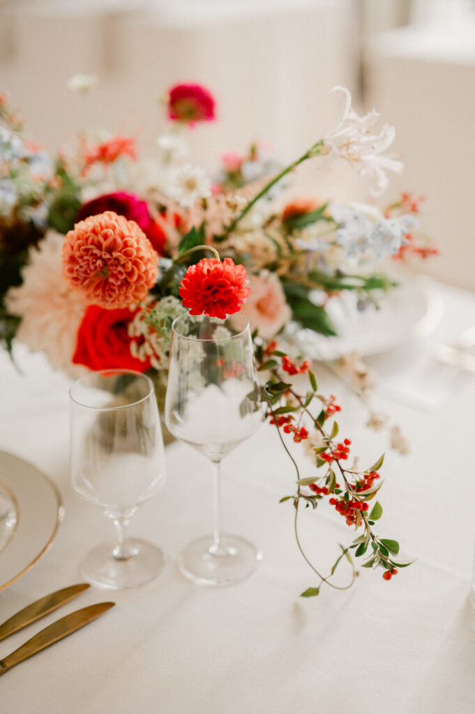 Wedding reception details with florals and wine glasses