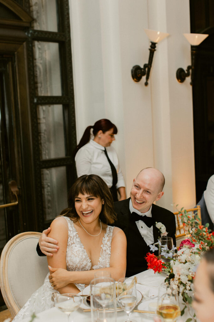Candid moment between bride and groom during wedding reception