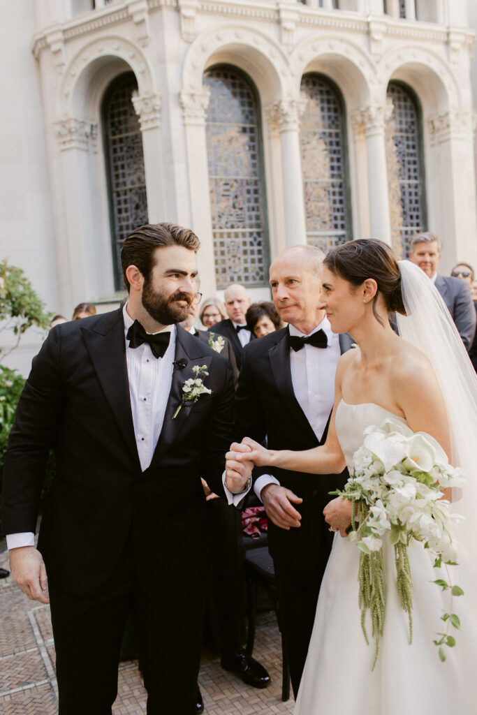 Bride and groom holding hands