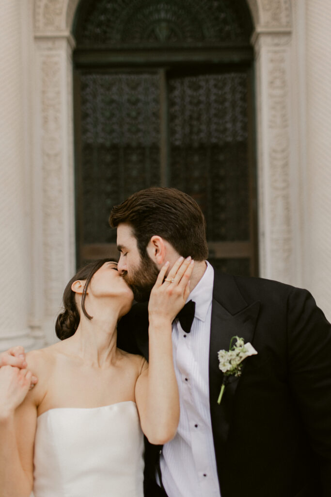 Bride and groom embracing outside Flood Mansion