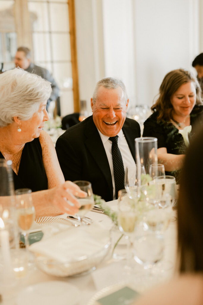 Guests laughing during Flood Mansion wedding reception