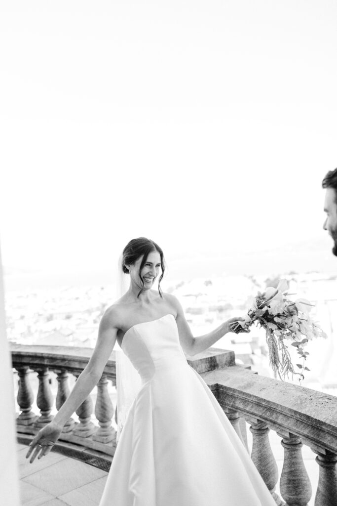 bride smiling at groom during first look