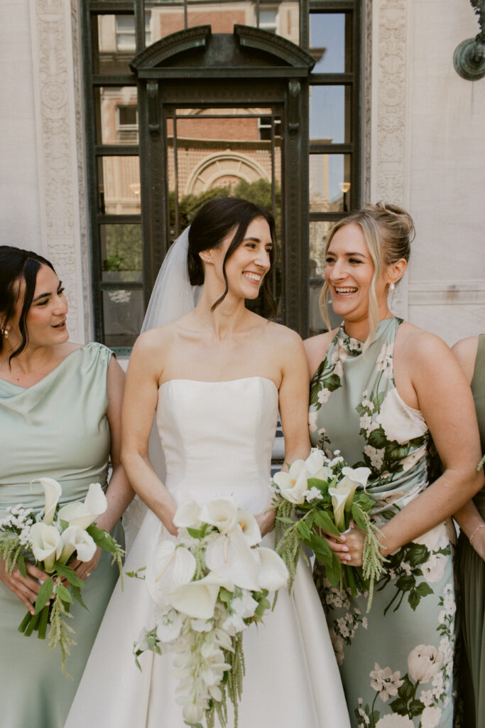 Bride smiling with sisters at Flood Mansion