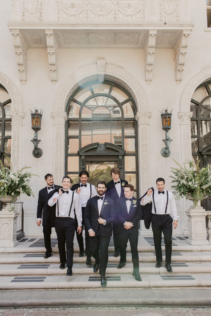 Candid groom with groomsmen on Flood Mansion steps