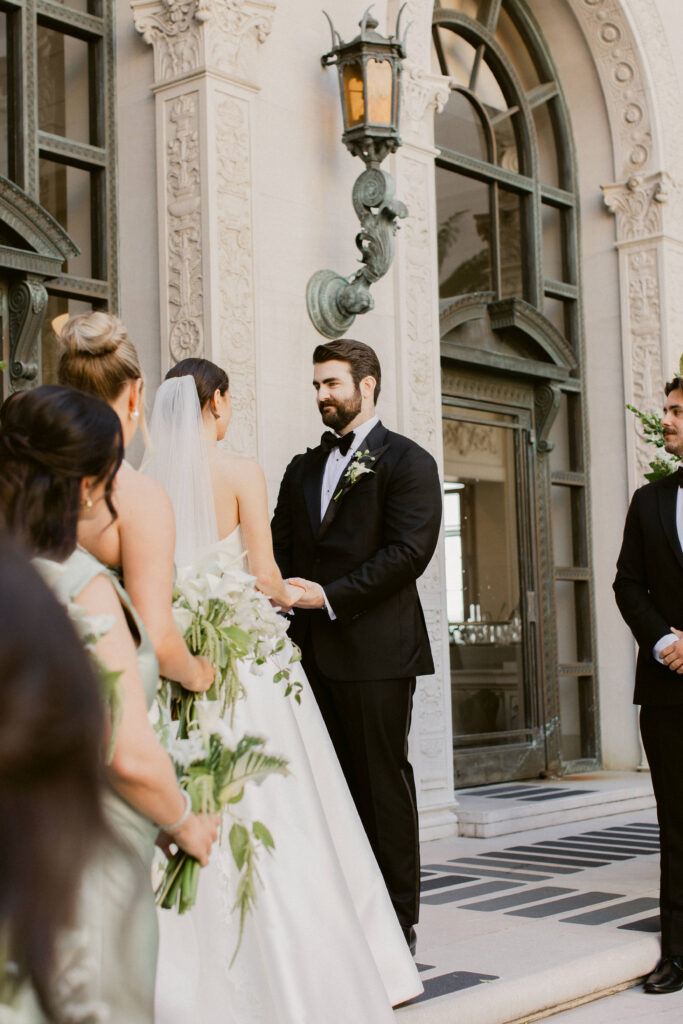 Bride and groom exchanging vows at Flood Mansion ceremony